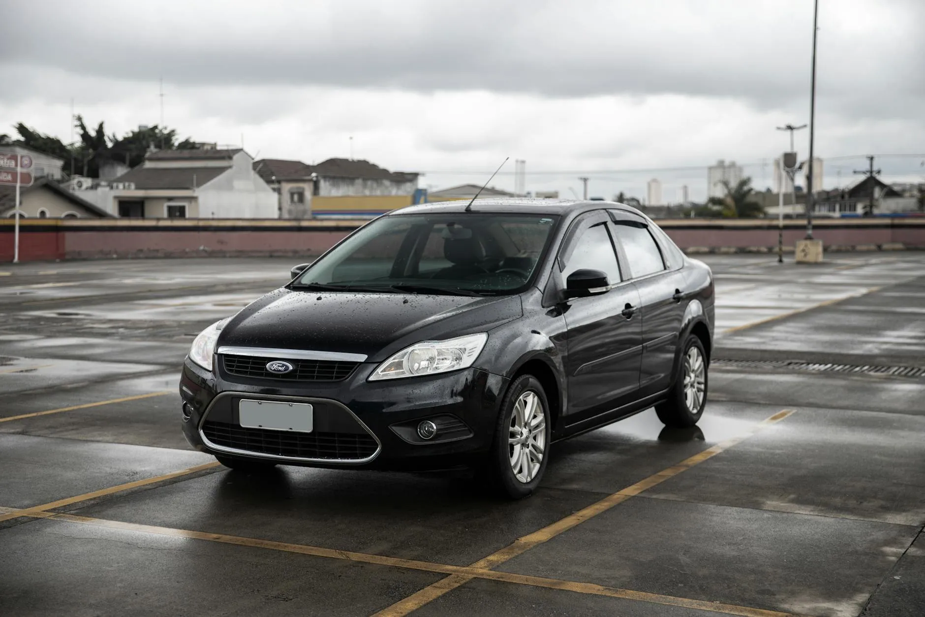 Compact sedan parked in a quiet lot, the kind of car the $7K budget actually buys