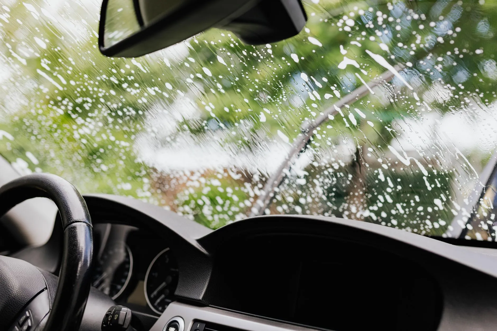 Cleaning the interior glass of a used car during a resale detail