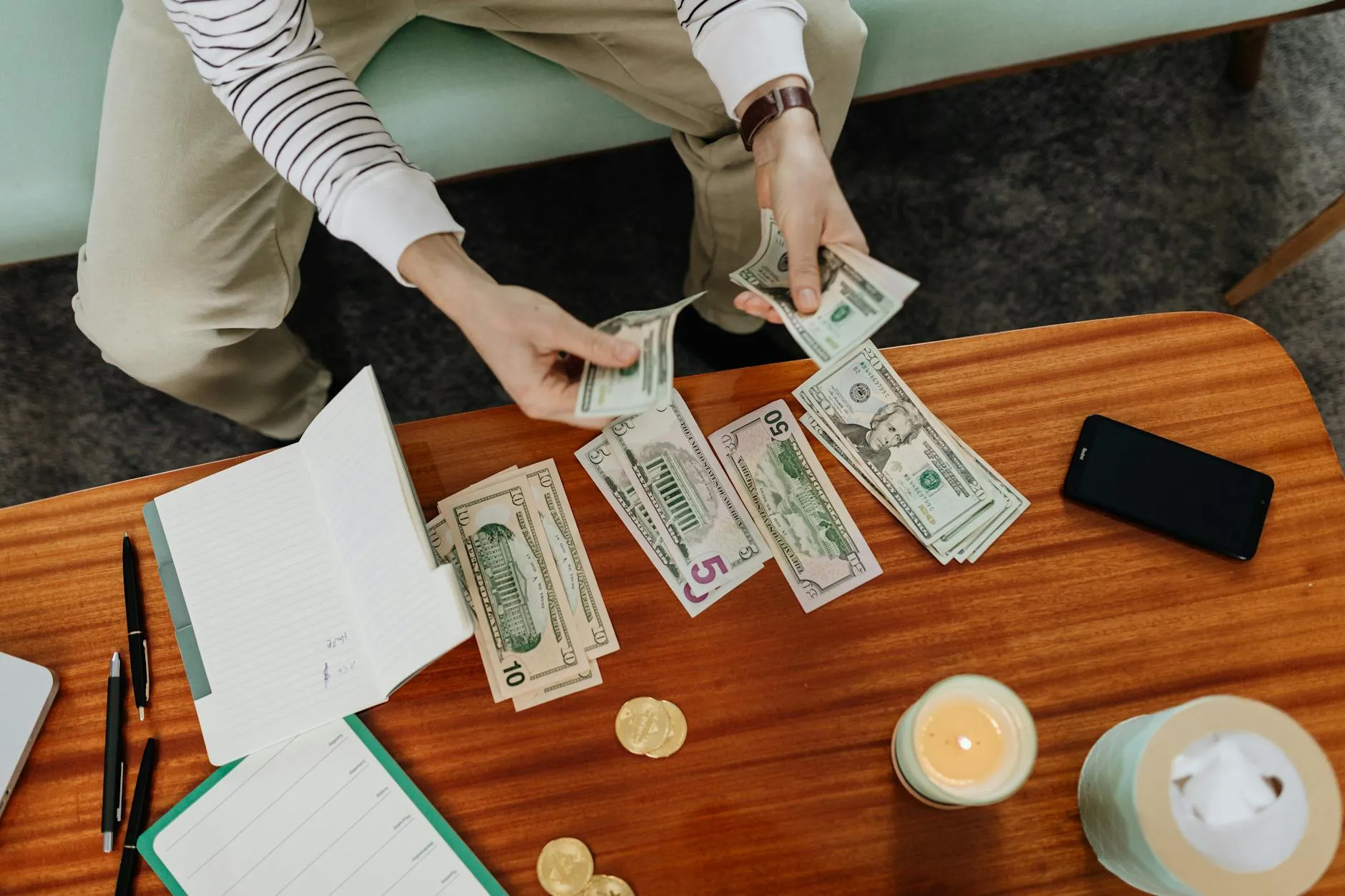 Person counting cash from car sale