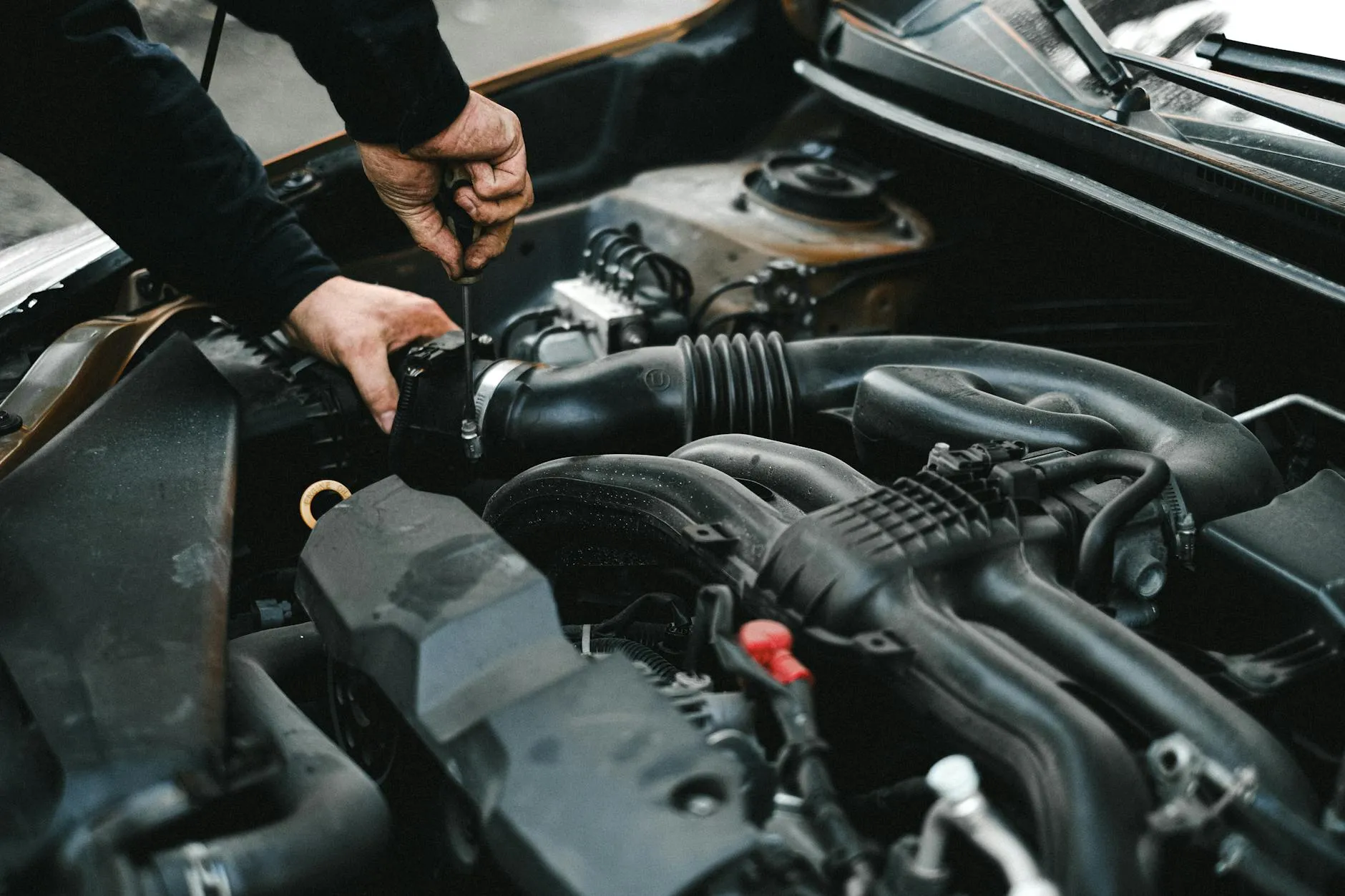 Mechanic working on car engine