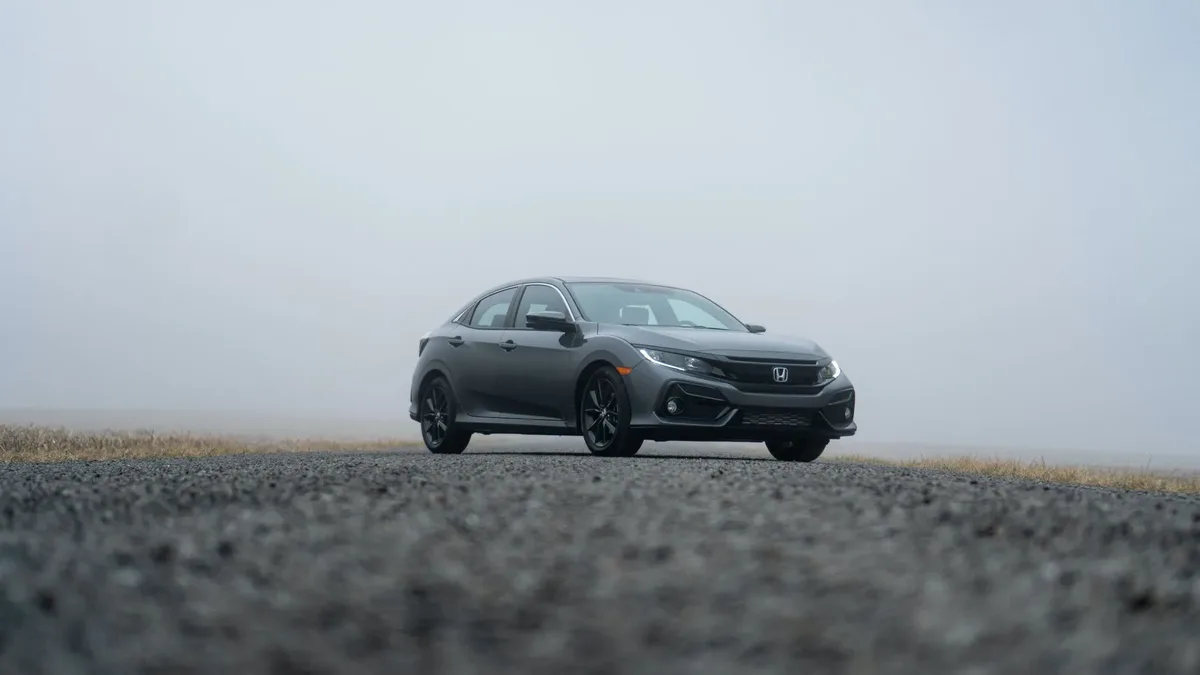 Gray tenth-generation Honda Civic hatchback on a foggy road