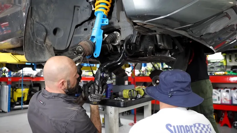 Mechanic inspecting a used car before purchase