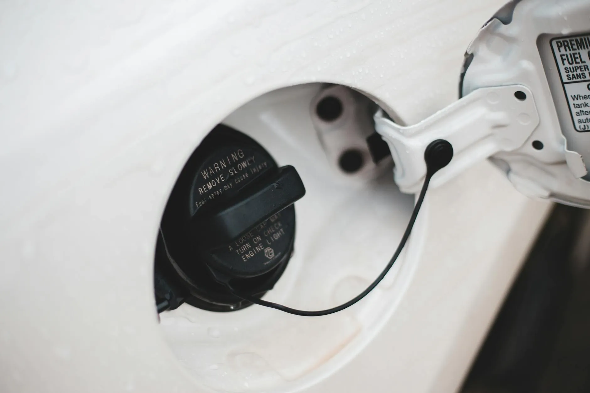 Close-up of car fuel cap with warning text