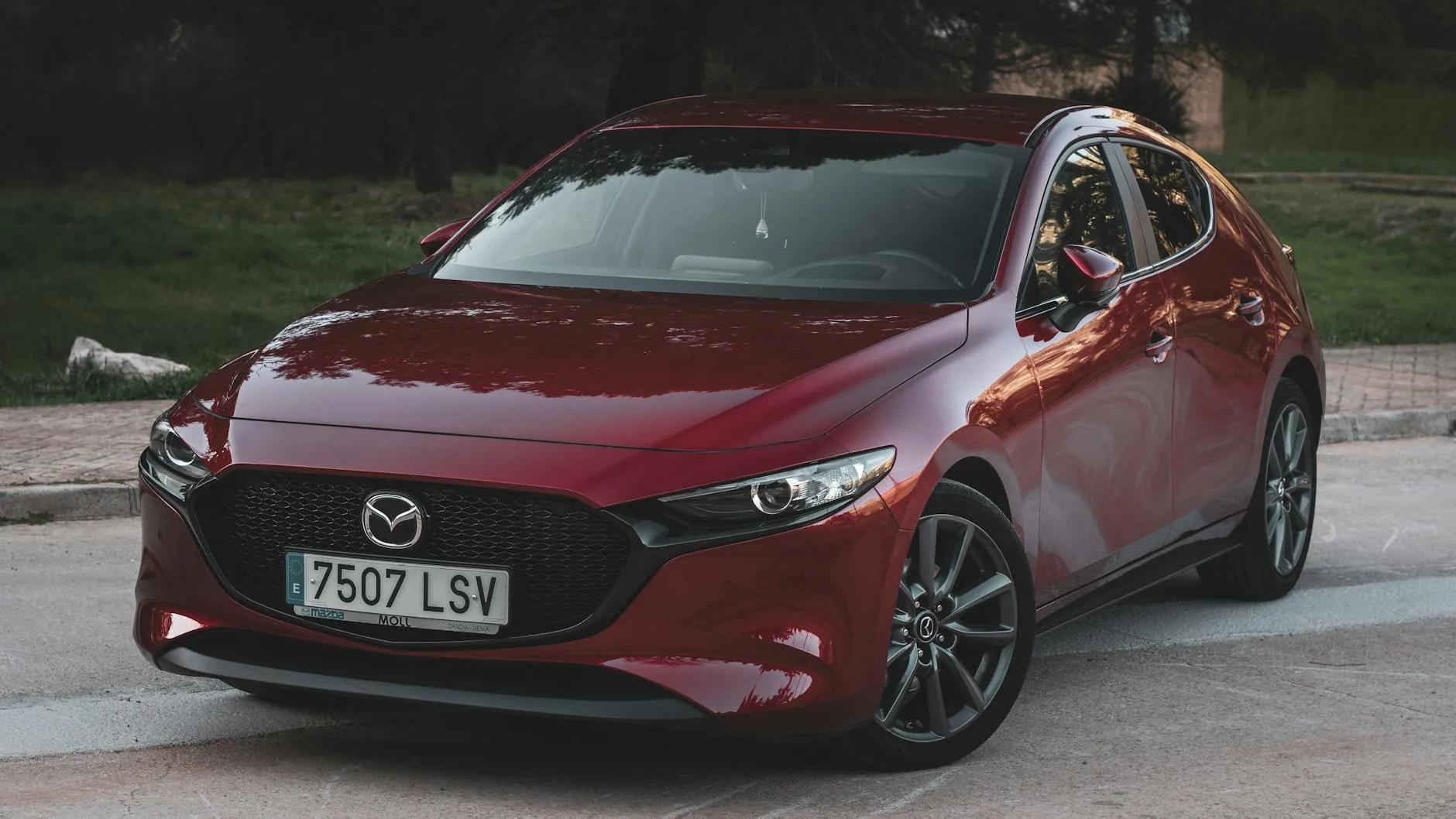 Red Mazda 3 parked outdoors