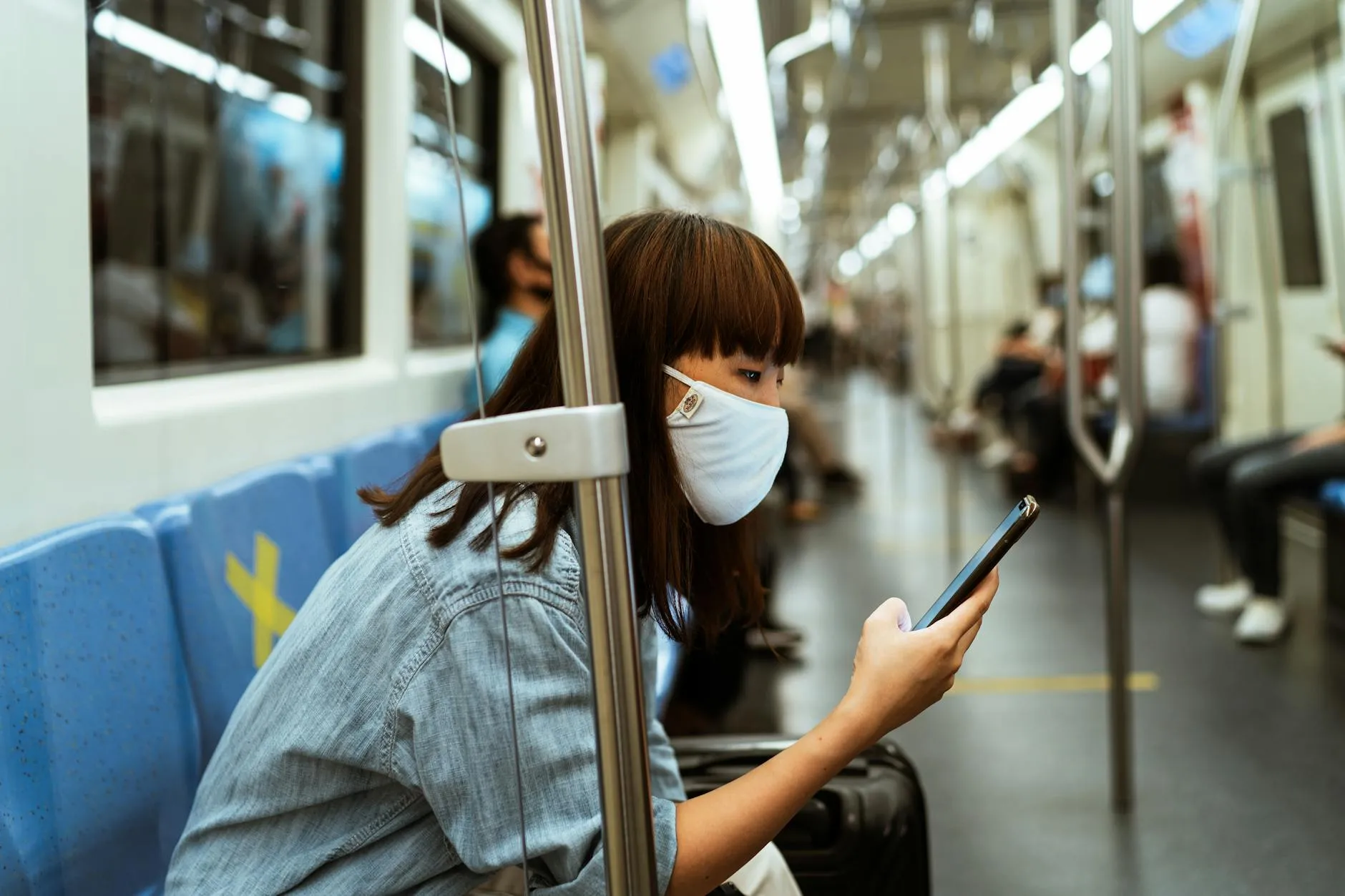 Woman using smartphone in public transit