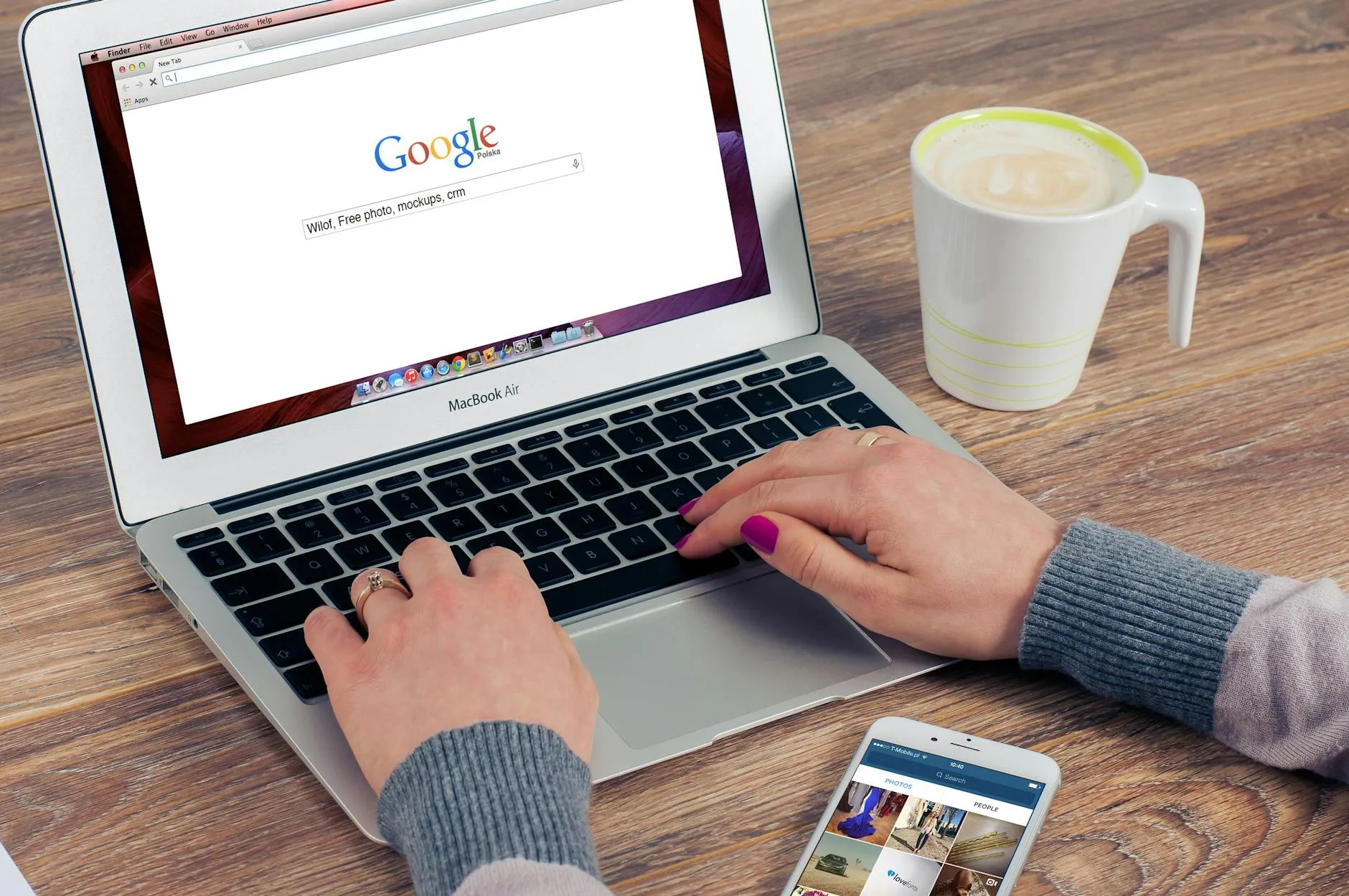 Person using MacBook with Google search