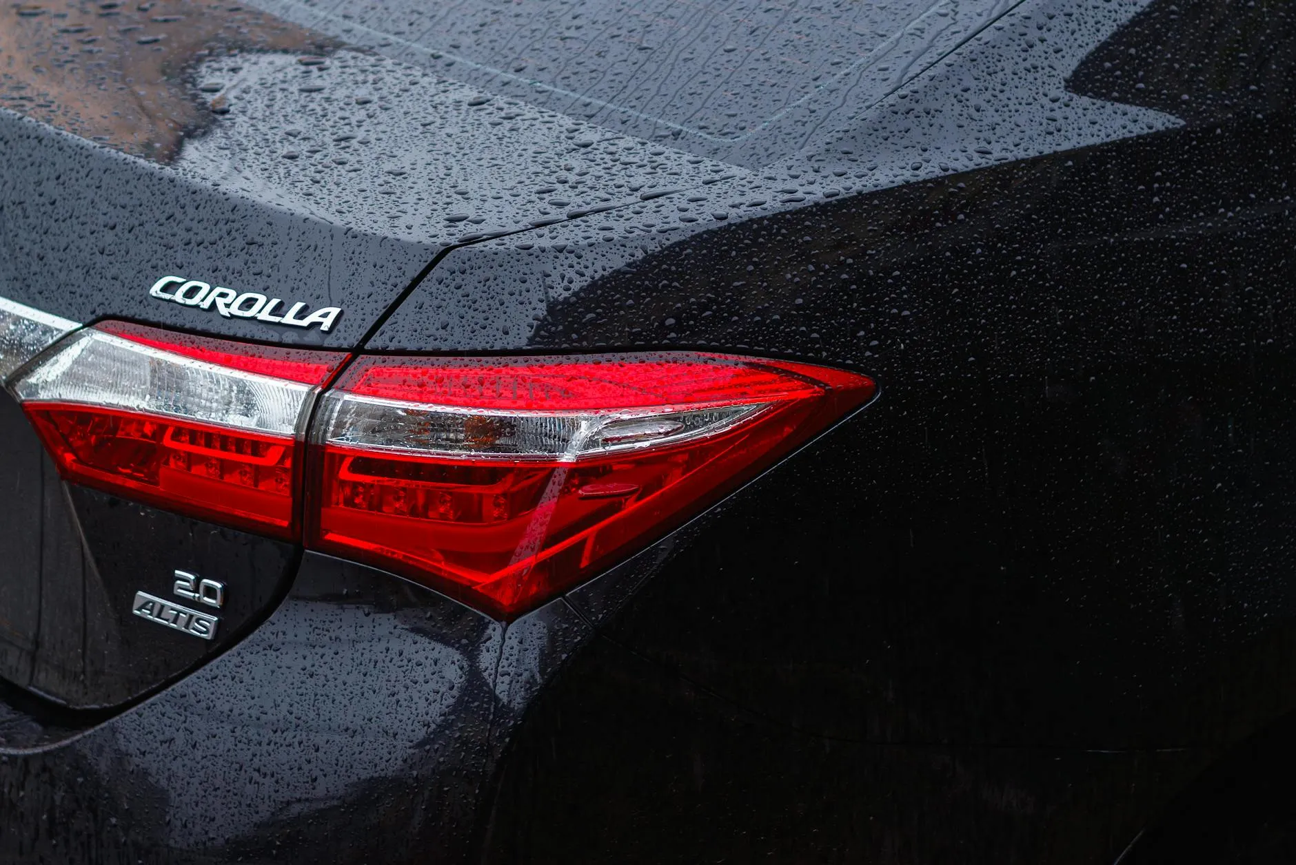 Black Toyota Corolla in the rain